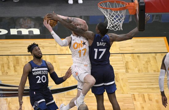 Orlando Magic forward Ignas Brazdeikis (17) is fouled by Minnesota Timberwolves center Ed Davis (17), right, while going up for a shot as Timberwolves forward Josh Okogie (20) watches during the second half of an NBA basketball game, Sunday, May 9, 2021, in Orlando, Fla. (AP Photo/Phelan M. Ebenhack)